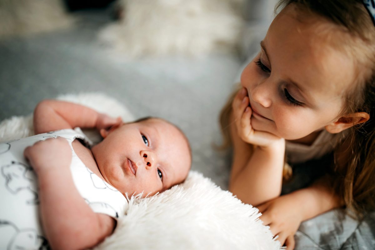 Big sister with her newborn sibling