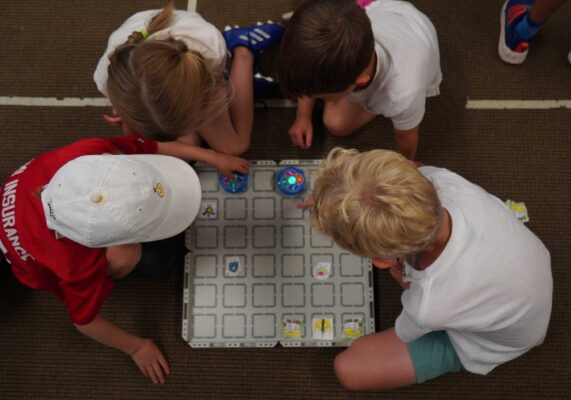 Students playing board game at St. Anne's Belfield Summer Camp, Charlottesville, Virginia