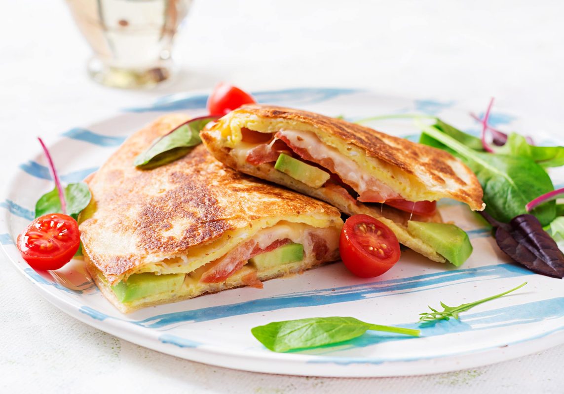 Healthy and easy breakfast quesadilla with egg, cheese, avocado and tomato perfect for children