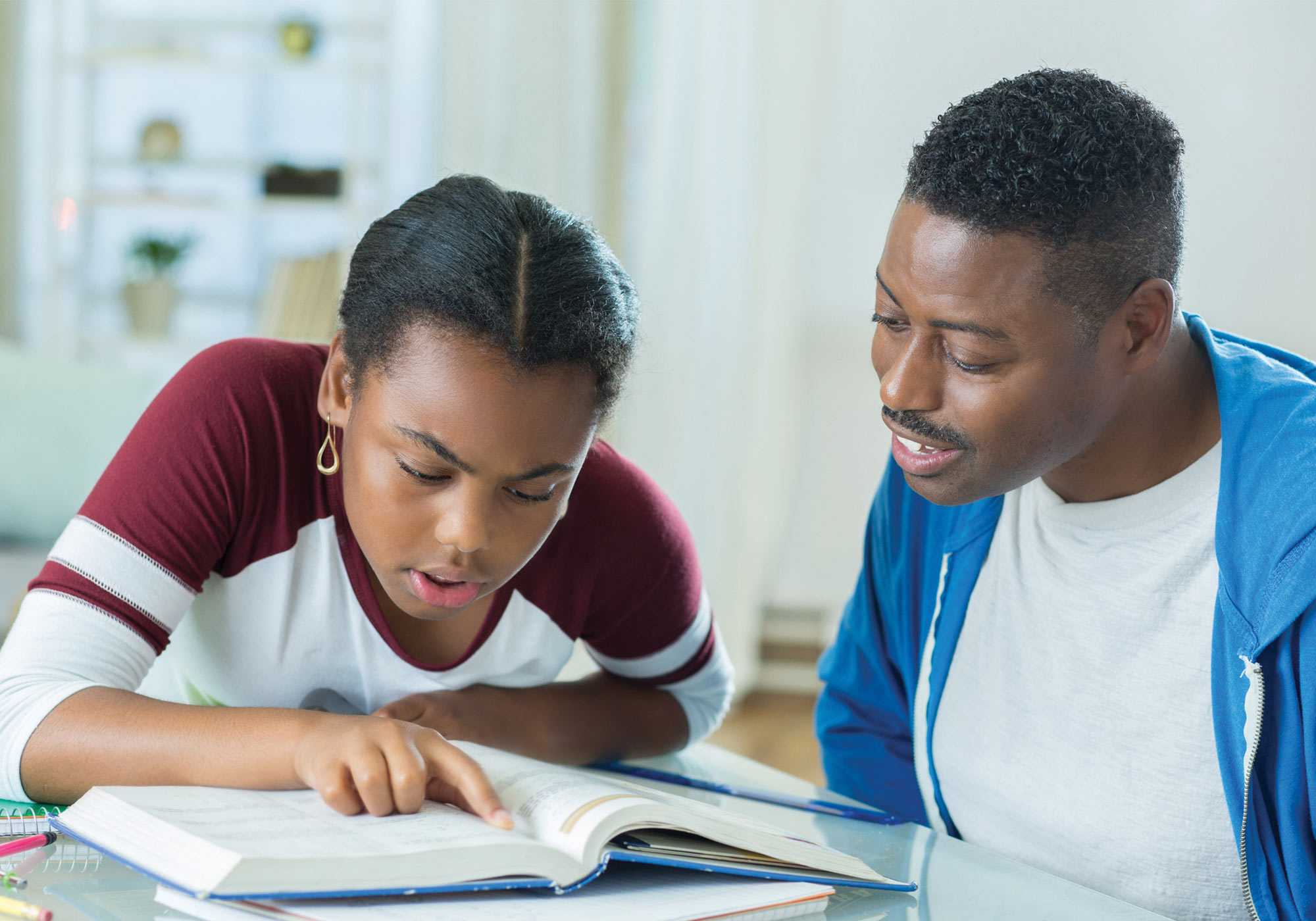 Dad helping teenage daughter with homework