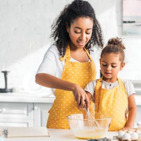 daughter helping mom in kitchen