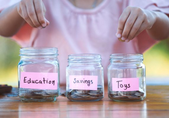 kid putting coins in jars