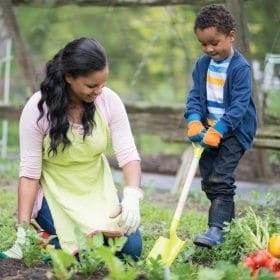 mom and son digging in garden