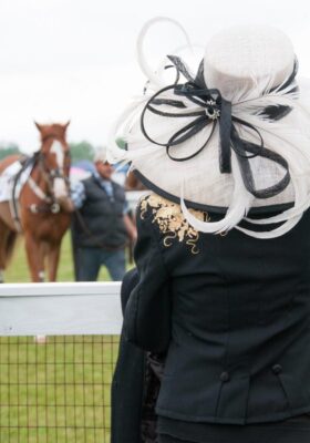 A woman at Foxfield Races wearing a beautiful hat