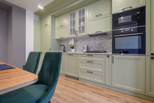 Modern light green luxurious kitchen with dining table
