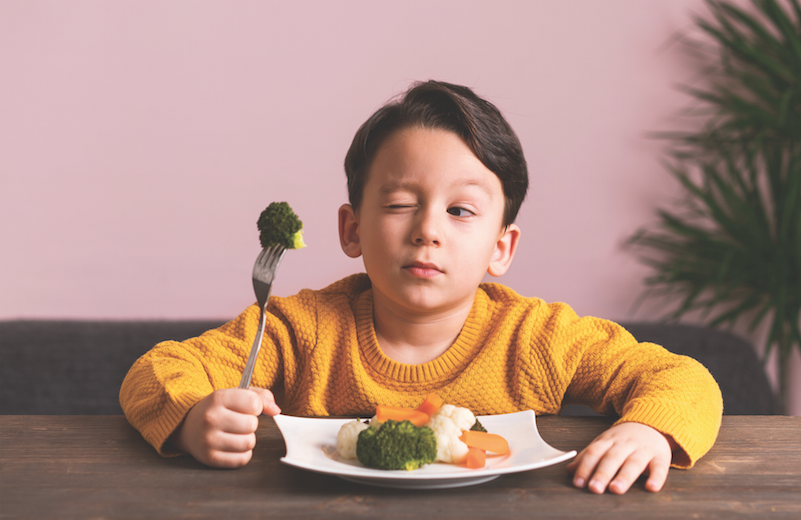 boy eating broccoli, picky eater