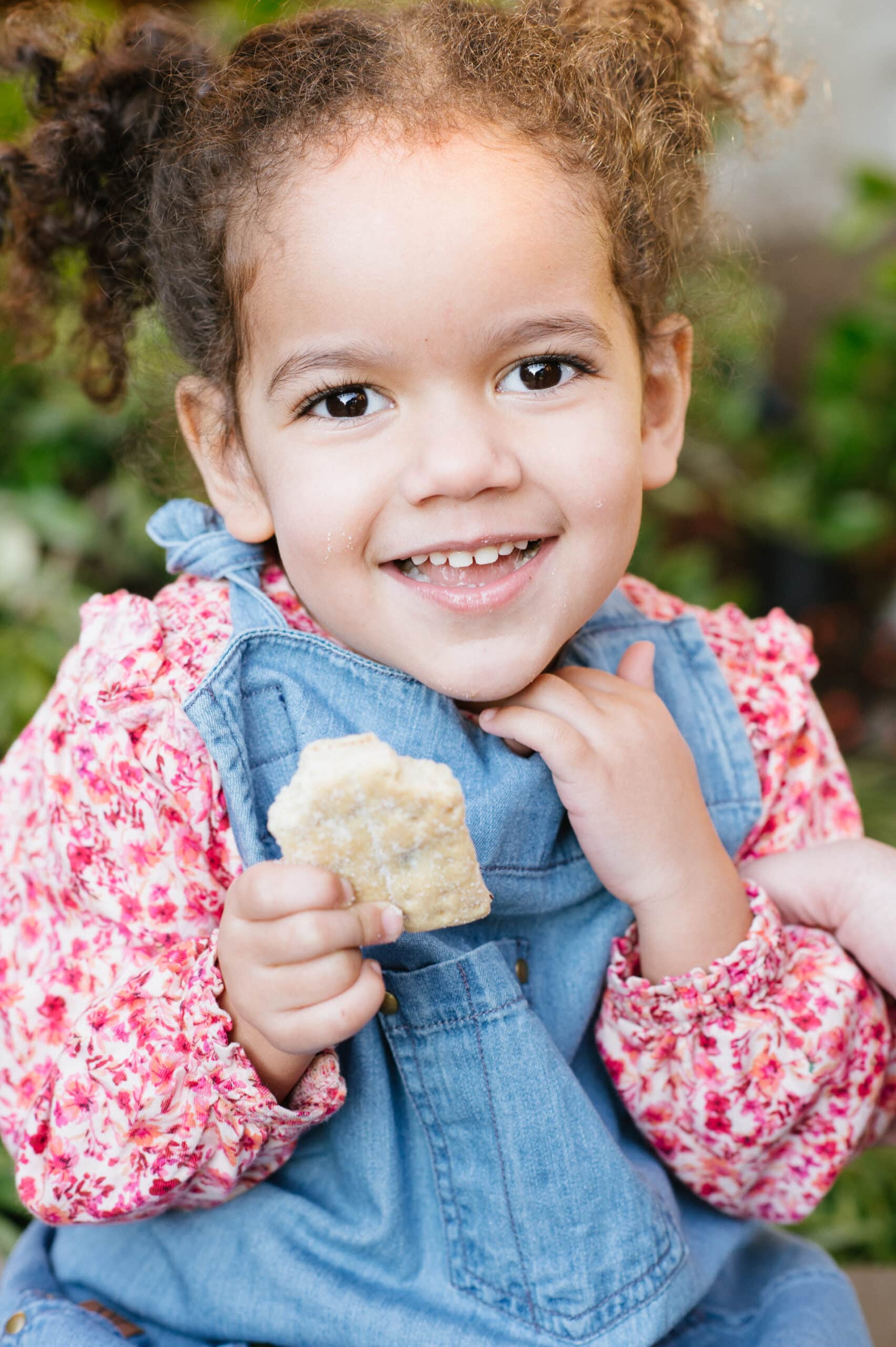 Toddler girl enjoying a snack of Allen's Scottish Shortbread cookies