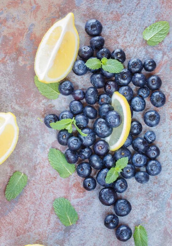 Blueberries and lemon slices with mint leaves