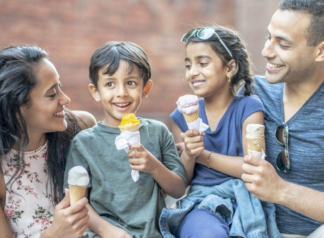 Middle Eastern family enjoying ice cream together in the summer time.