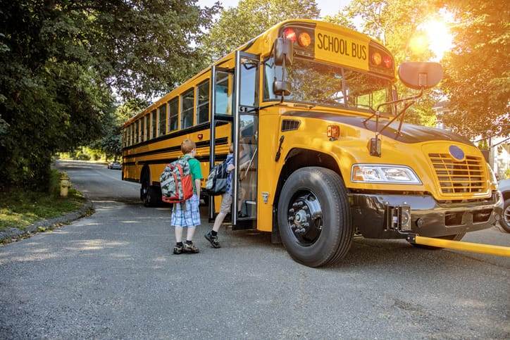 kids getting on school bus
