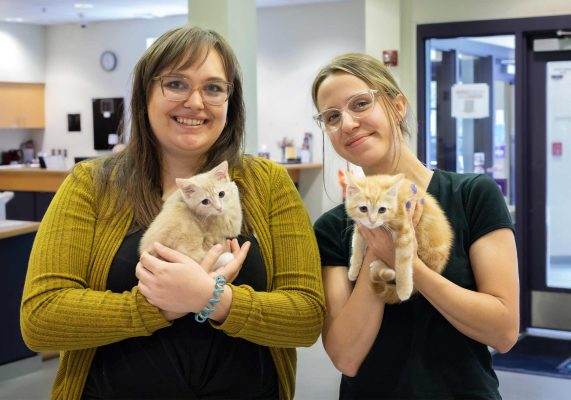 CASPCA volunteers holding kittens