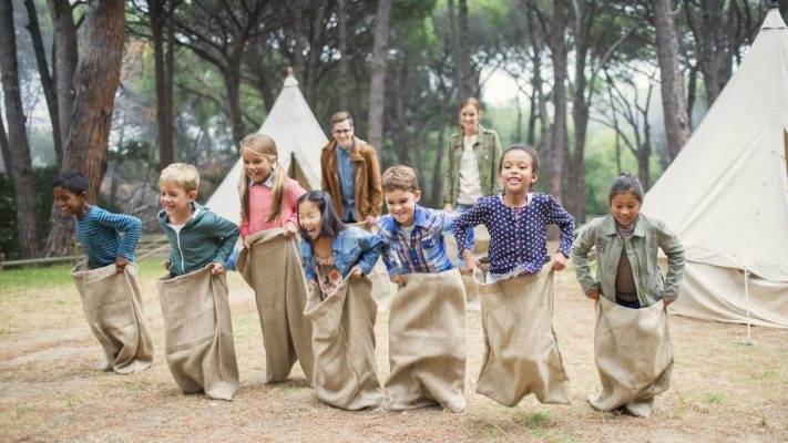 kids doing a sack race at camp