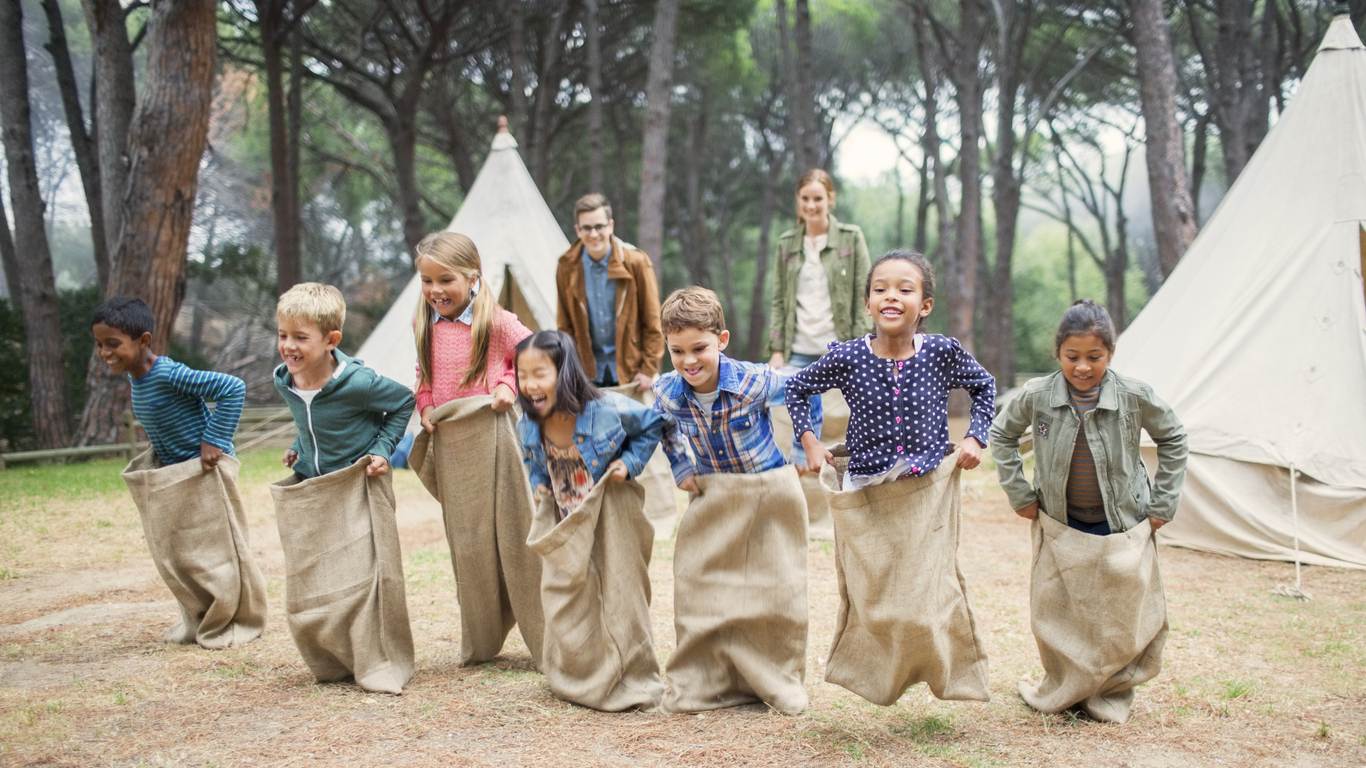 kids doing a sack race at camp