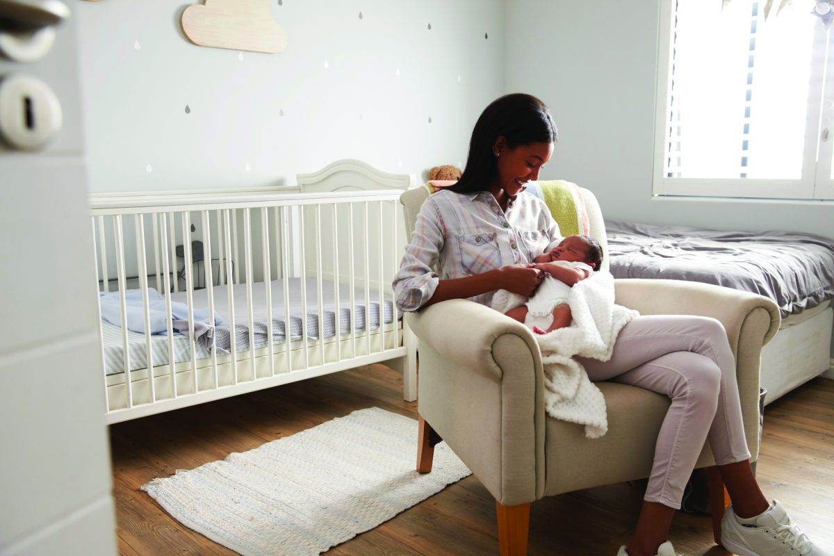 Mom feeding baby in nursery
