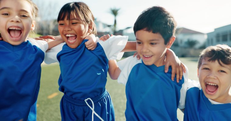 Children, soccer team and portrait with hug on field, celebration and excited for sports tournament. Friends, boys and girls with support for winning, game goal and group of football players on pitch