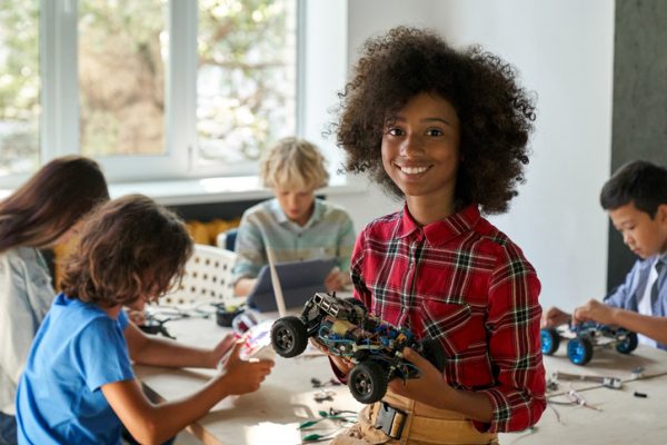 STEAm spring break camp featuring child with robotics and car model