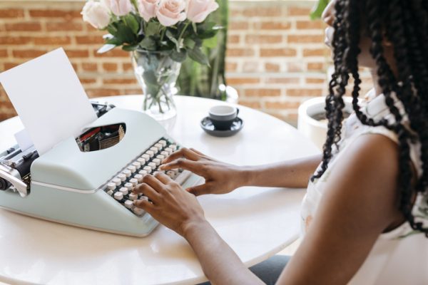 mom writing on vintage typewriter