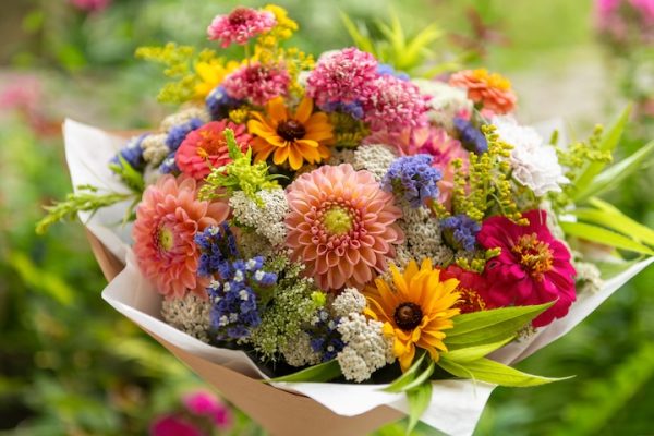 Summer bouquet. Beautiful multi colored fresh flower arrangement. Birthday bouquet made of summer flowers photographed outdoors.